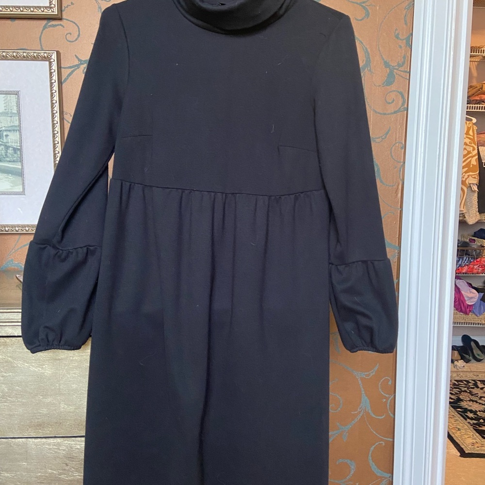 Stylish black dress with 3/4 length slightly flared sleeve.
